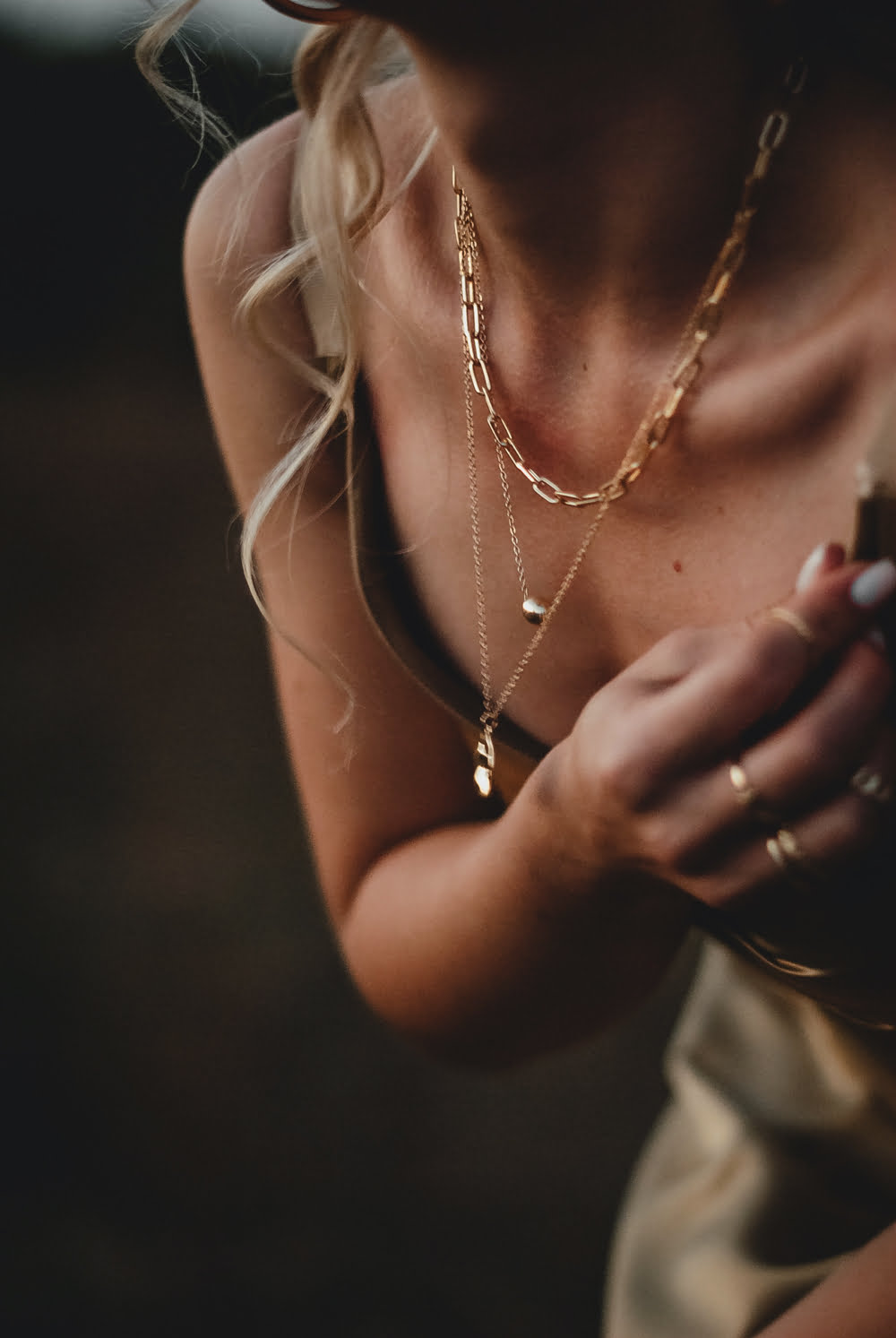 Girl with gold chains, pendants, and rings